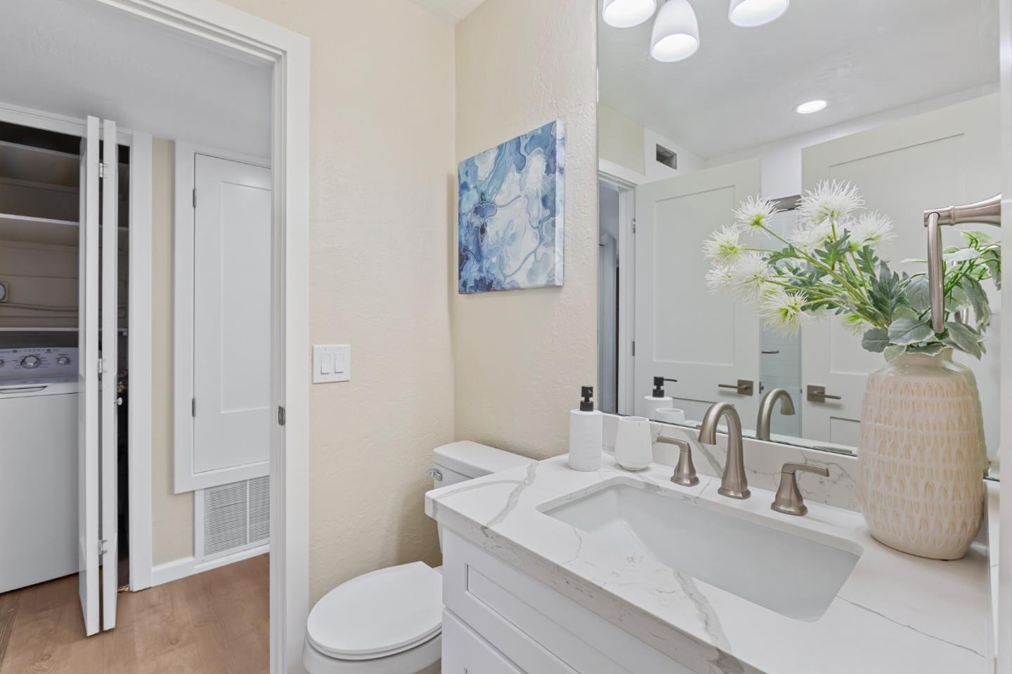 8 Cassandra Way Mountain View, CA 94043 - Photo 22 of 35 a bathroom with a sink a toilet and a large mirror