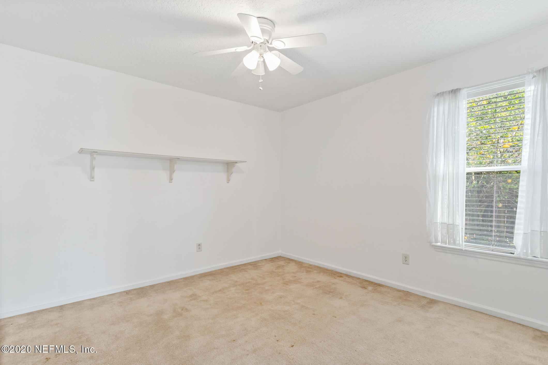 2514 Paris Mill Road Jacksonville, FL 32221 - Photo 22 of 29 an empty room with a window and a ceiling fan