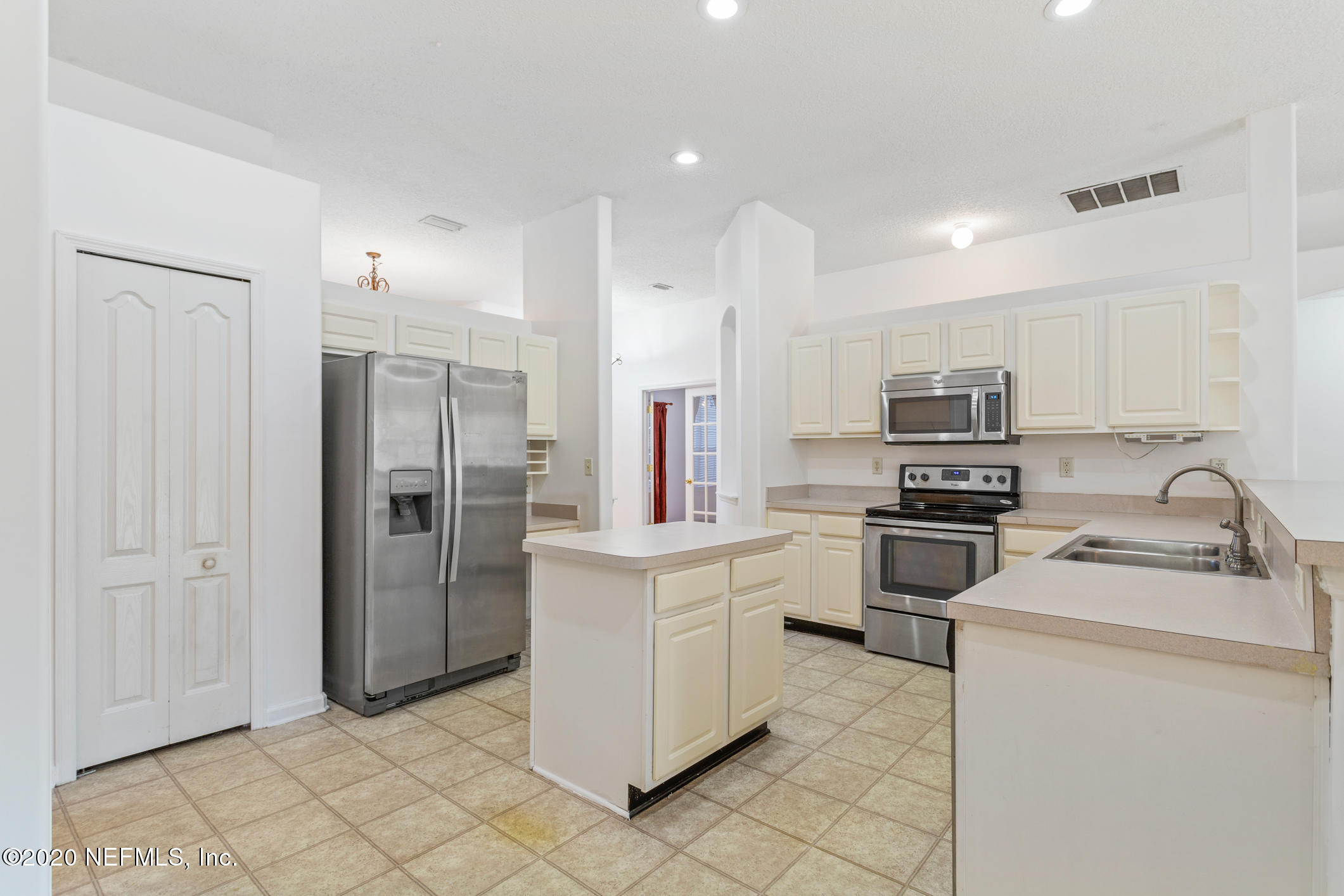 2514 Paris Mill Road Jacksonville, FL 32221 - Photo 9 of 29 a kitchen with stainless steel appliances a refrigerator stove microwave and sink