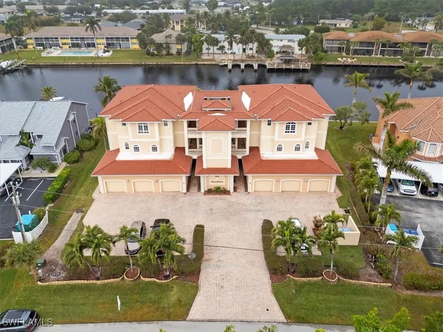 an aerial view of a house with a lake view