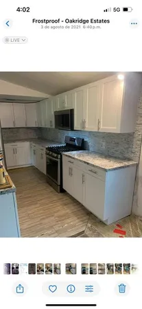 a kitchen with a stove a sink and a microwave