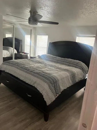 a bedroom with a bed and a large mirror