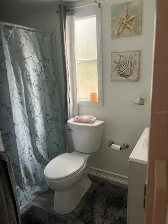 a bathroom with a toilet sink and shower
