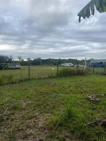 a view of a field with an ocean