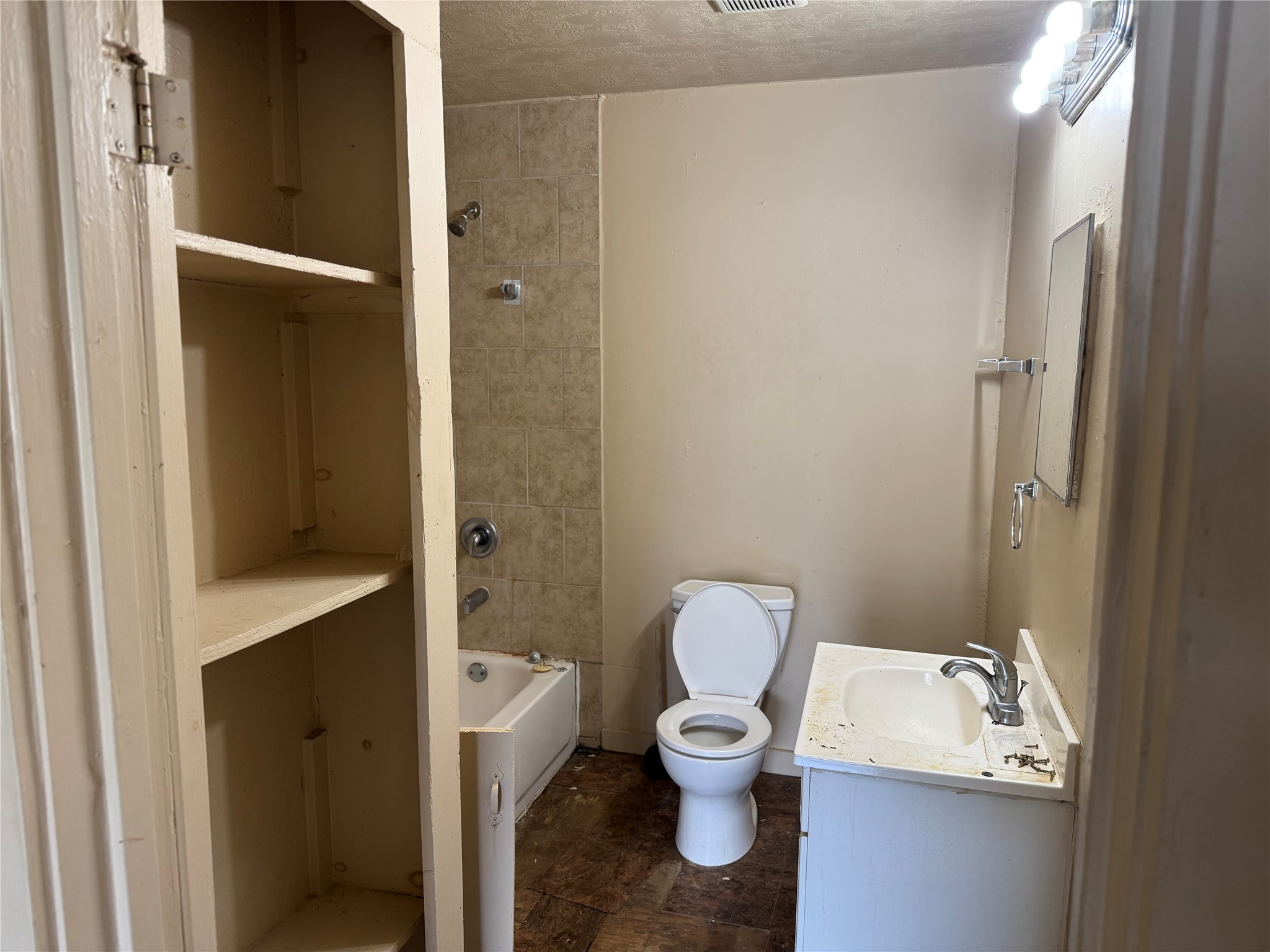 606 East 42nd Street Houston, TX 77022 - Photo 9 of 14 a white toilet sitting next to a bathroom sink