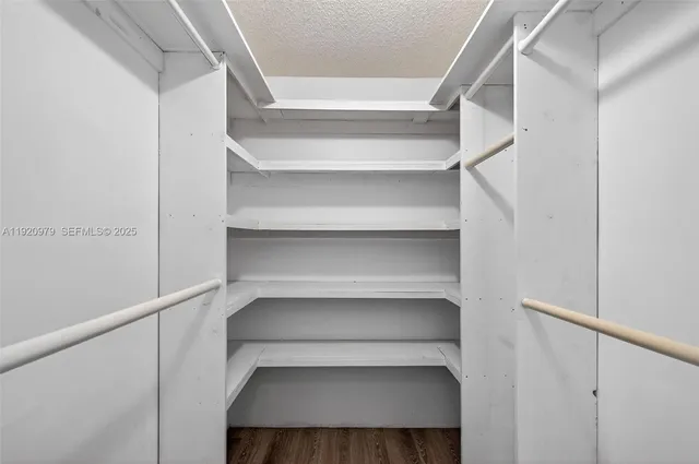 a view of room with white walls and a window