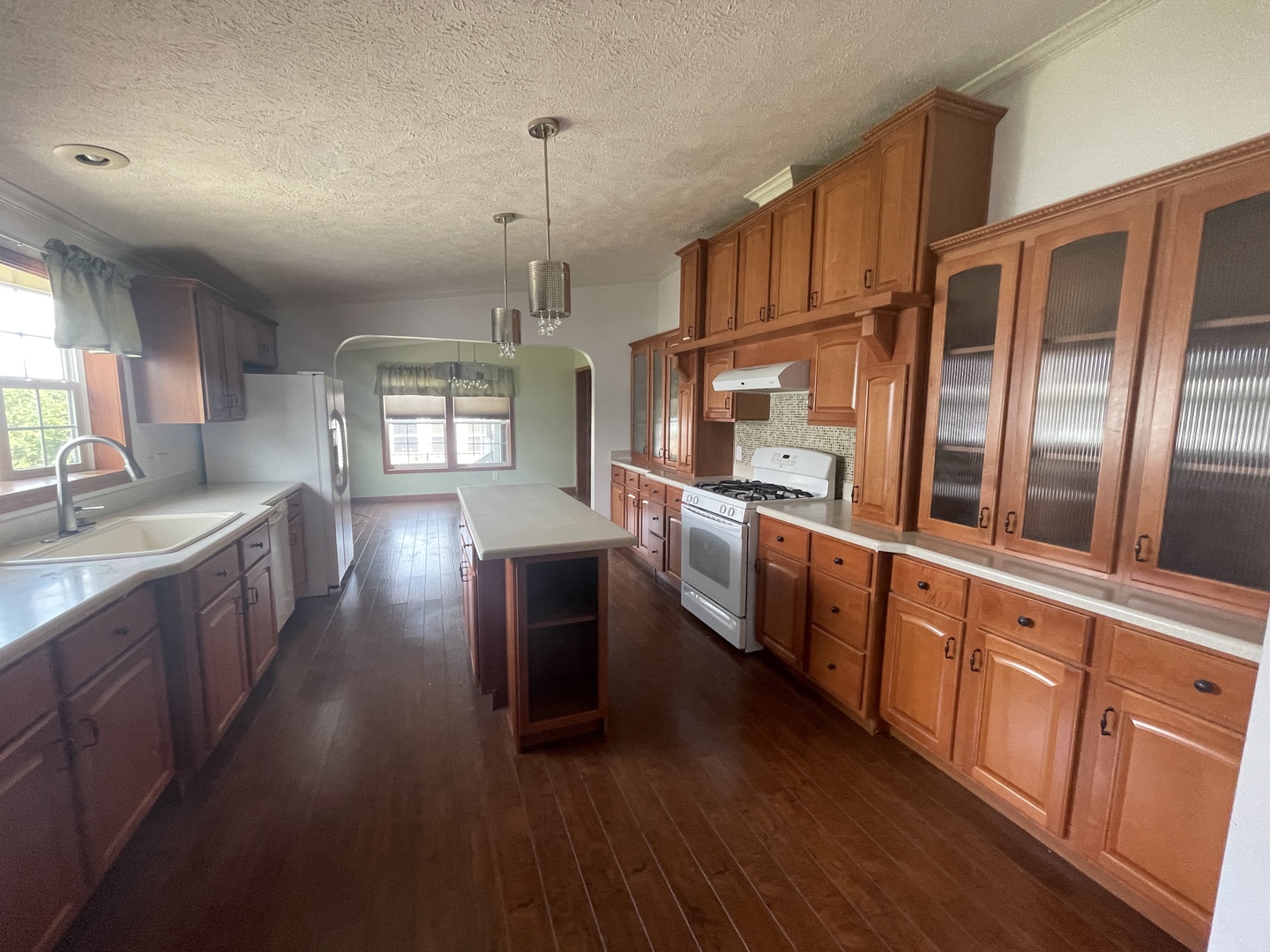 67 Crocus Lane Matteson, IL 60443 - Photo 8 of 30 a open kitchen with stainless steel appliances granite countertop a stove a sink dishwasher a refrigerator and wooden cabinets with wooden floor
