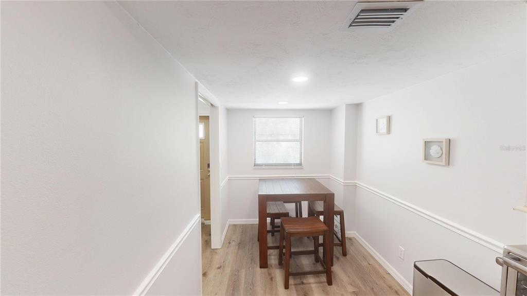 8735 Midnight Pass Road, Unit 206B Sarasota, FL 34242 - Photo 21 of 56 a workspace with furniture and wooden floor