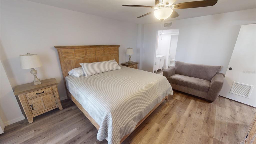 8735 Midnight Pass Road, Unit 206B Sarasota, FL 34242 - Photo 26 of 56 a bedroom with a bed and a couch