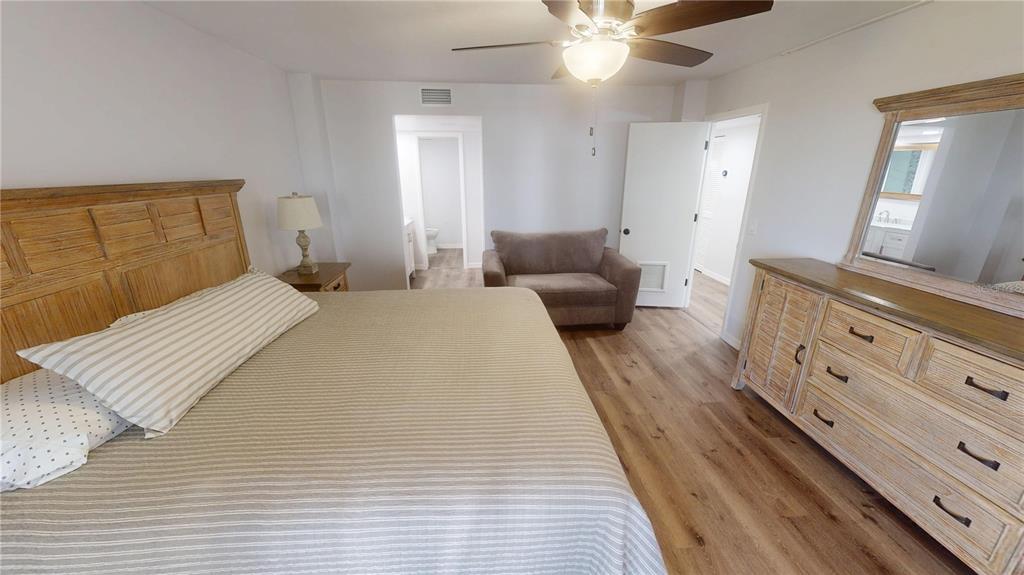 8735 Midnight Pass Road, Unit 206B Sarasota, FL 34242 - Photo 27 of 56 a bed room with a bed and a mirror