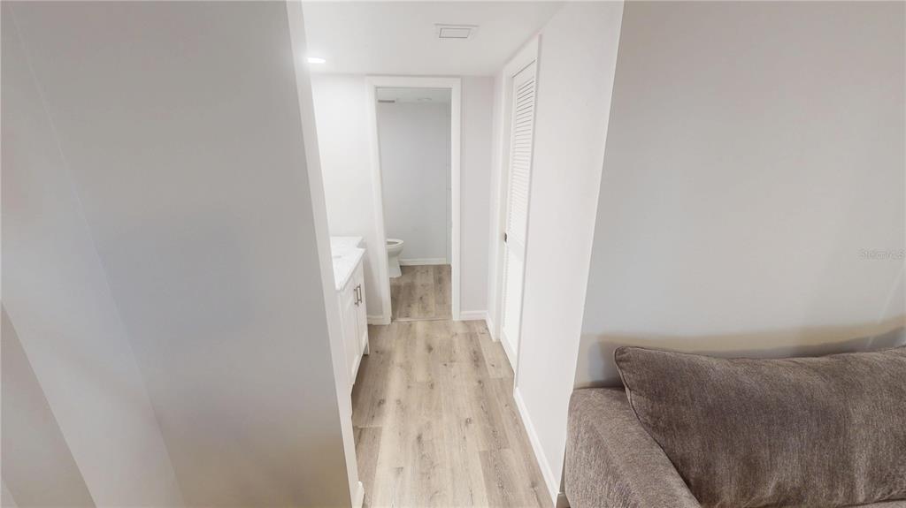 8735 Midnight Pass Road, Unit 206B Sarasota, FL 34242 - Photo 29 of 56 a view of a room with wooden floor and a bathroom