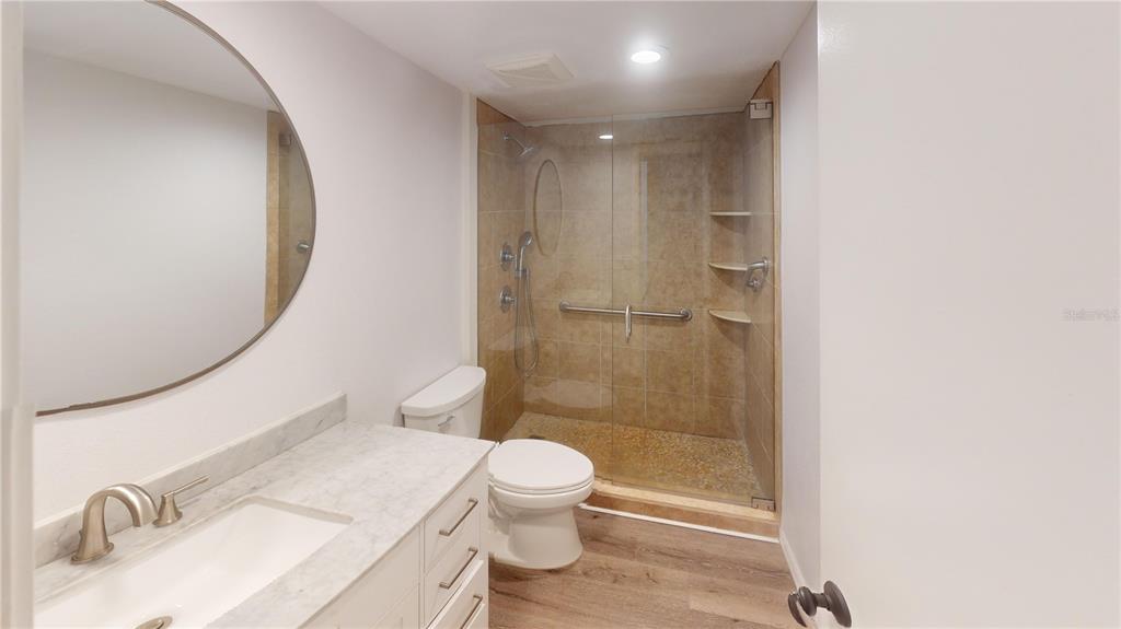 8735 Midnight Pass Road, Unit 206B Sarasota, FL 34242 - Photo 34 of 56 a bathroom with a sink a toilet and shower