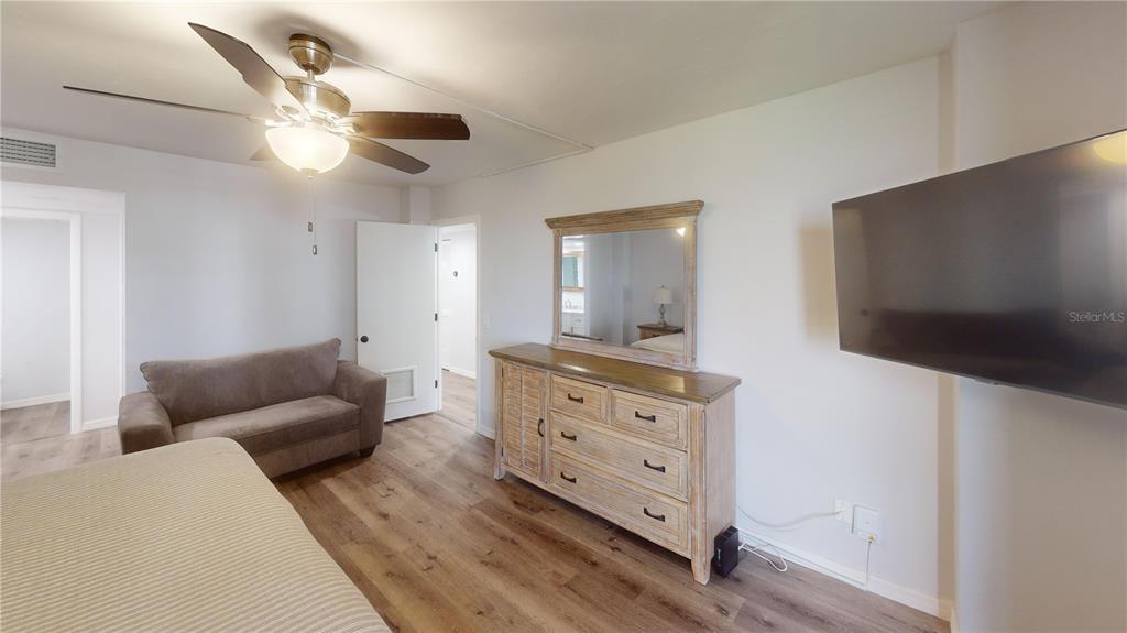 8735 Midnight Pass Road, Unit 206B Sarasota, FL 34242 - Photo 38 of 56 a living room with furniture and a flat screen tv