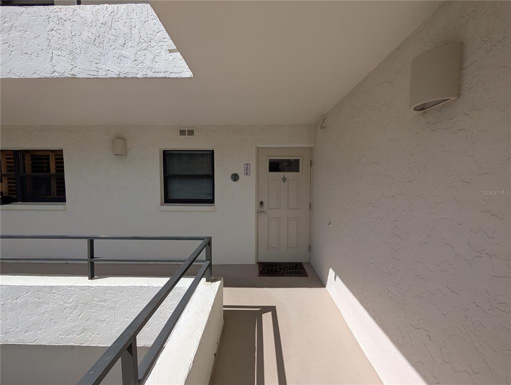 8735 Midnight Pass Road, Unit 206B Sarasota, FL 34242 - Photo 48 of 56 a view of a living room with stainless steel appliances wooden floor and a fireplace