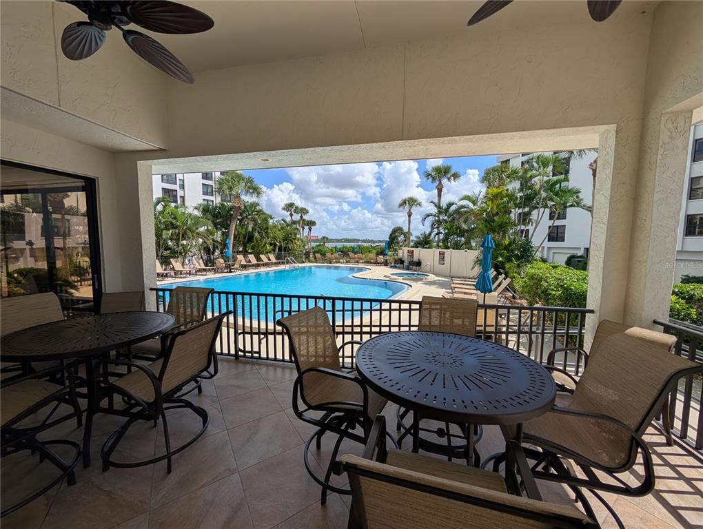 8735 Midnight Pass Road, Unit 206B Sarasota, FL 34242 - Photo 51 of 56 a view of a chairs and table in patio