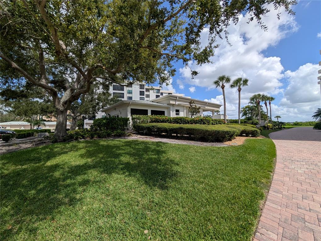 8735 Midnight Pass Road, Unit 206B Sarasota, FL 34242 - Photo 53 of 56 a view of a fountain in front of a house with a big yard