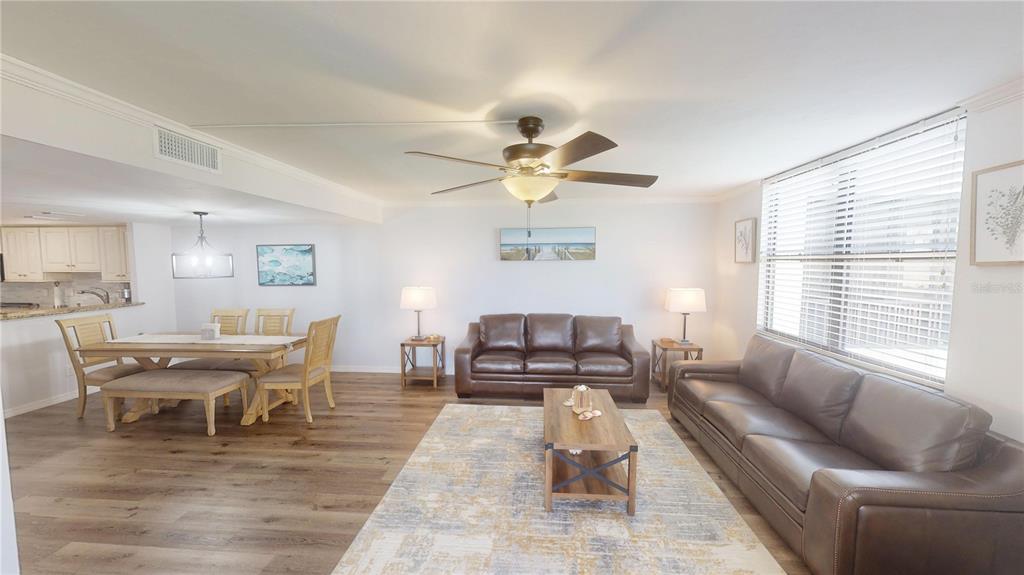 8735 Midnight Pass Road, Unit 206B Sarasota, FL 34242 - Photo 7 of 56 a living room with furniture and a large window