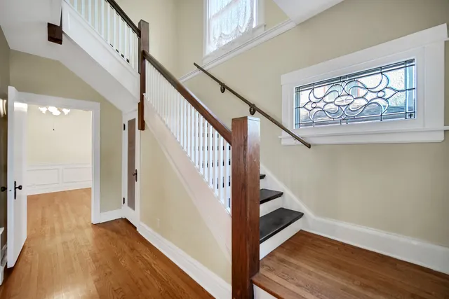 a view of an entryway with wooden floor and stairs