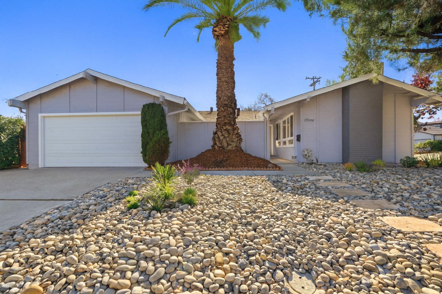19990 Pear Tree Lane Cupertino, CA 95014 - Photo 2 of 38 a front view of a house with garden