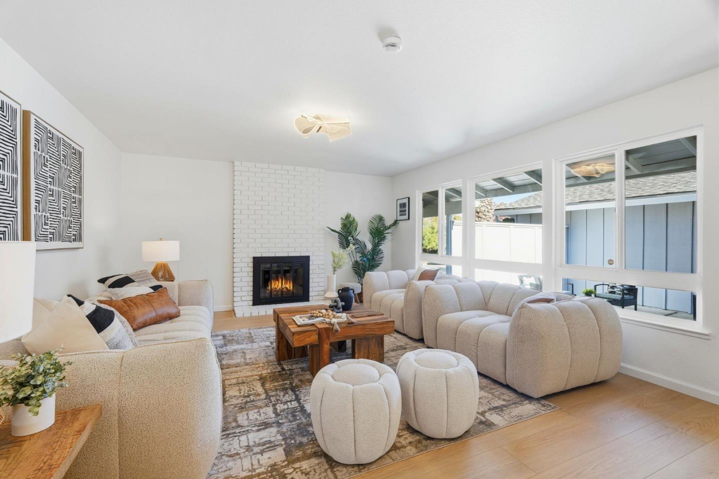19990 Pear Tree Lane Cupertino, CA 95014 - Photo 8 of 38 a living room with furniture a fireplace and a potted plant