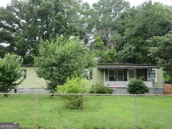 a front view of house with yard and trees