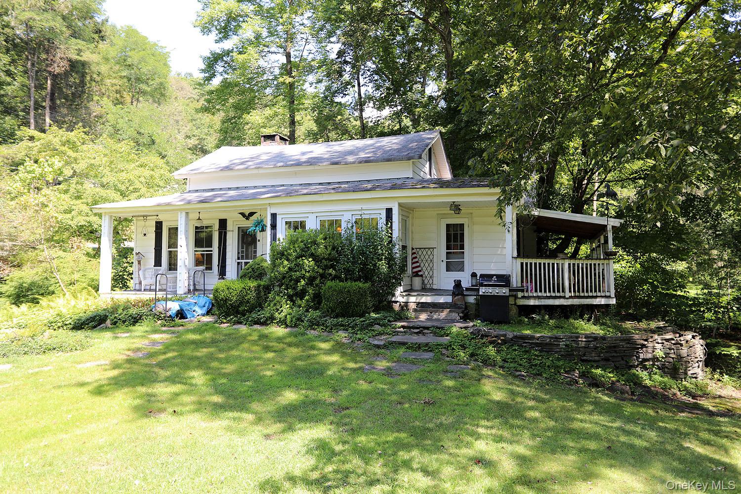 a view of a house with a yard and sitting area