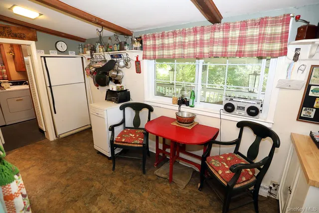 a kitchen with refrigerator and window