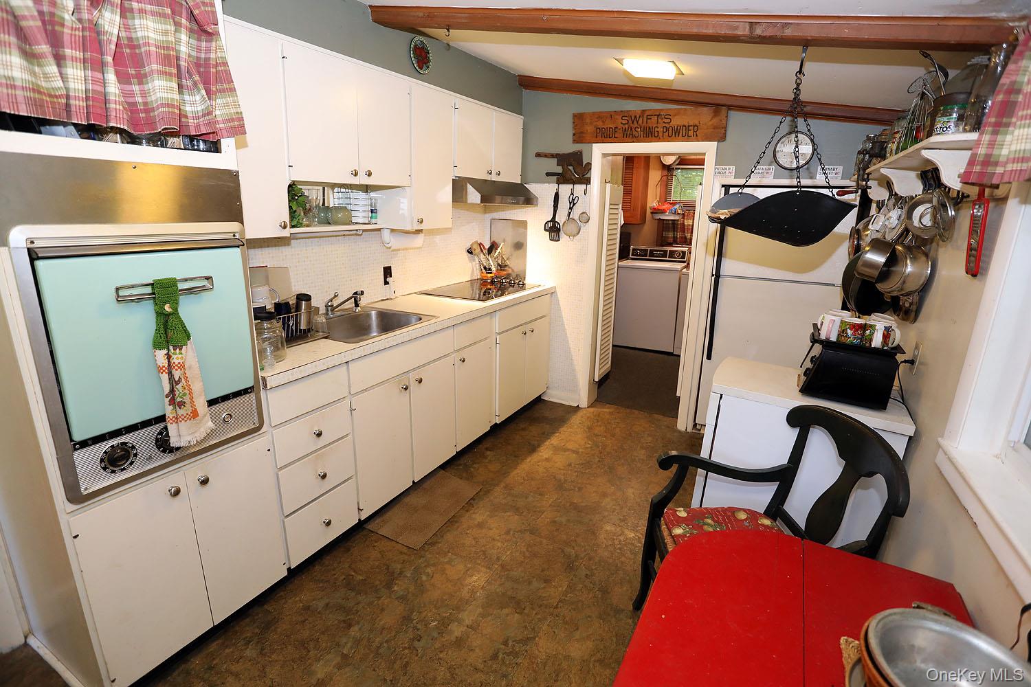 66 Raspberry Park Road Long Eddy, NY 12760 - Photo 16 of 36 Kitchen featuring white cabinets, light countertops and under cabinet range hood