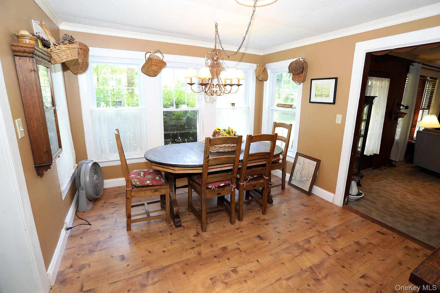 66 Raspberry Park Road Long Eddy, NY 12760 - Photo 18 of 36 Dining space featuring light wood-style floors, crown molding, and a chandelier