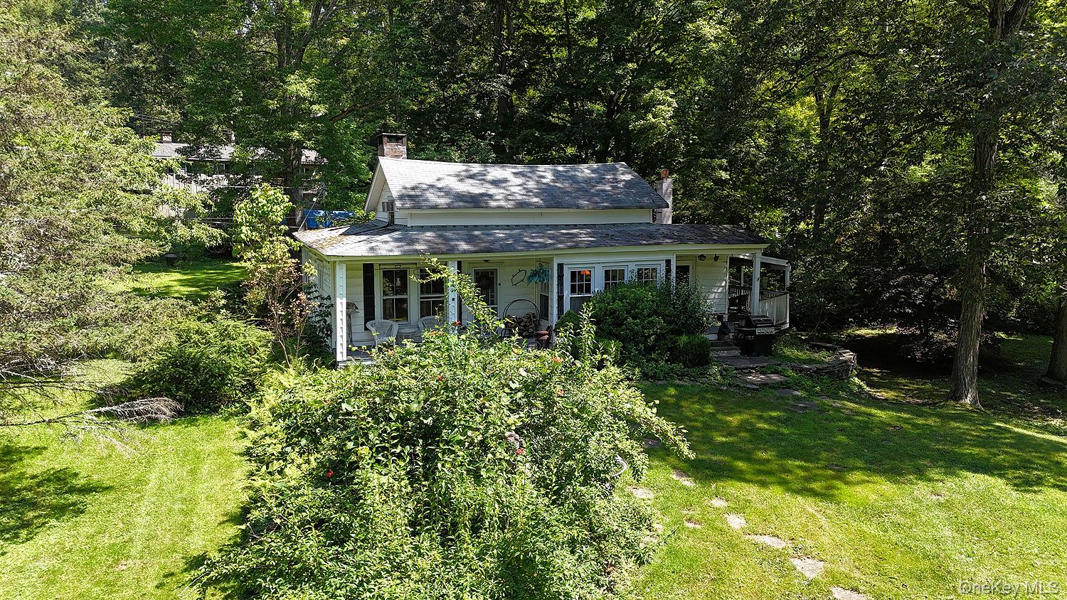 66 Raspberry Park Road Long Eddy, NY 12760 - Photo 2 of 36 View of front of property featuring a chimney, a front yard, and covered porch