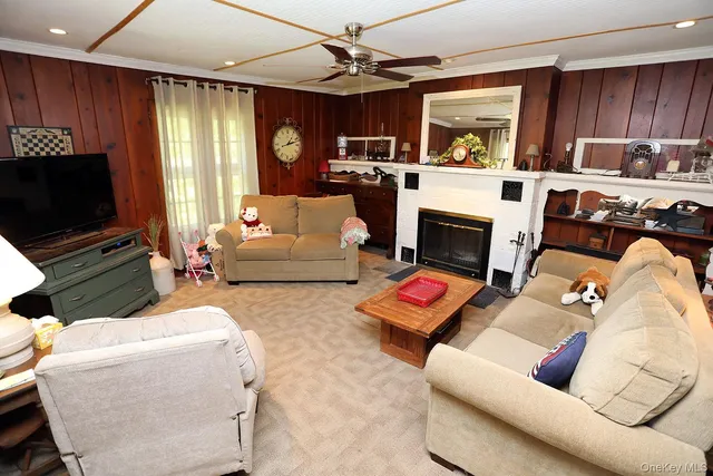 a living room with furniture fireplace and flat screen tv