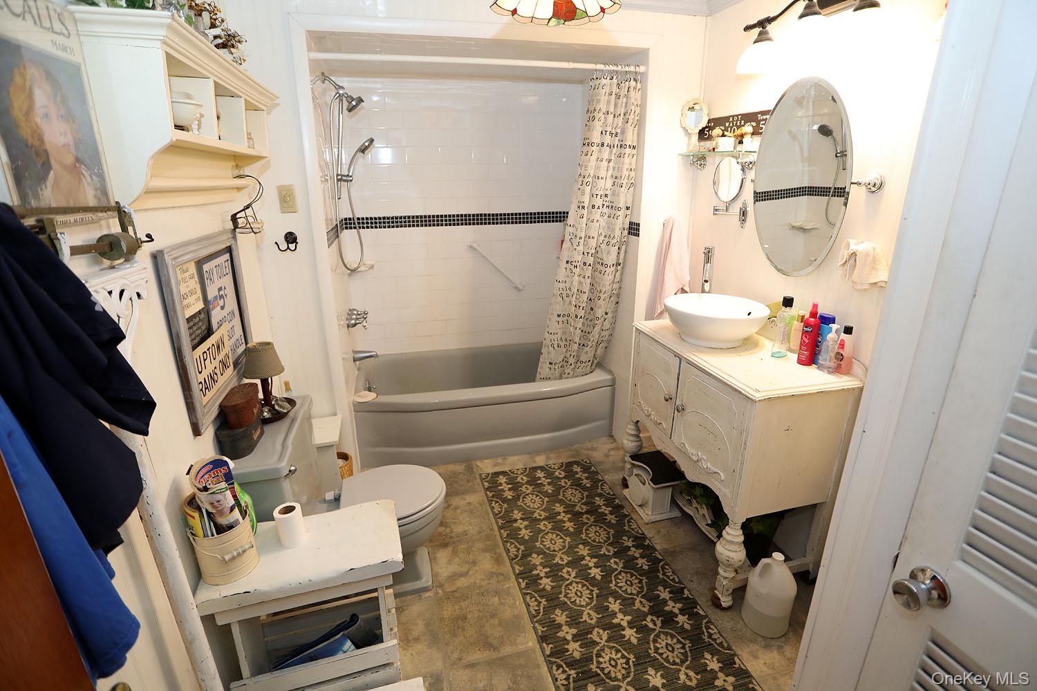 66 Raspberry Park Road Long Eddy, NY 12760 - Photo 27 of 36 Bathroom featuring shower / bath combination with curtain, vanity, and light tile patterned floors