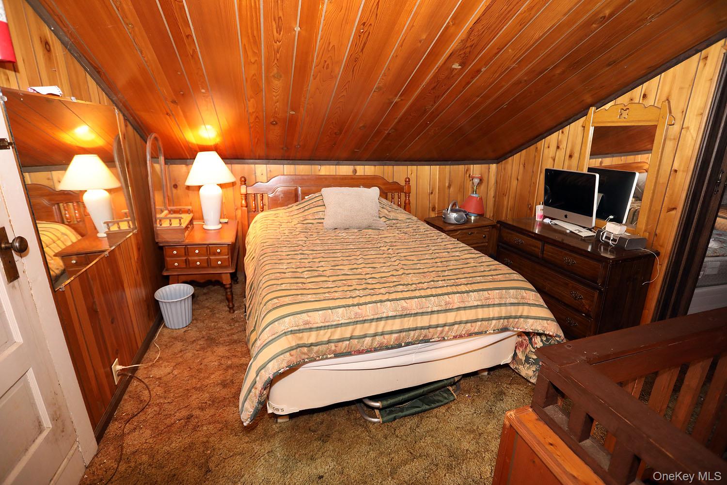 66 Raspberry Park Road Long Eddy, NY 12760 - Photo 28 of 36 Bedroom with wooden walls, wood ceiling, and dark colored carpet