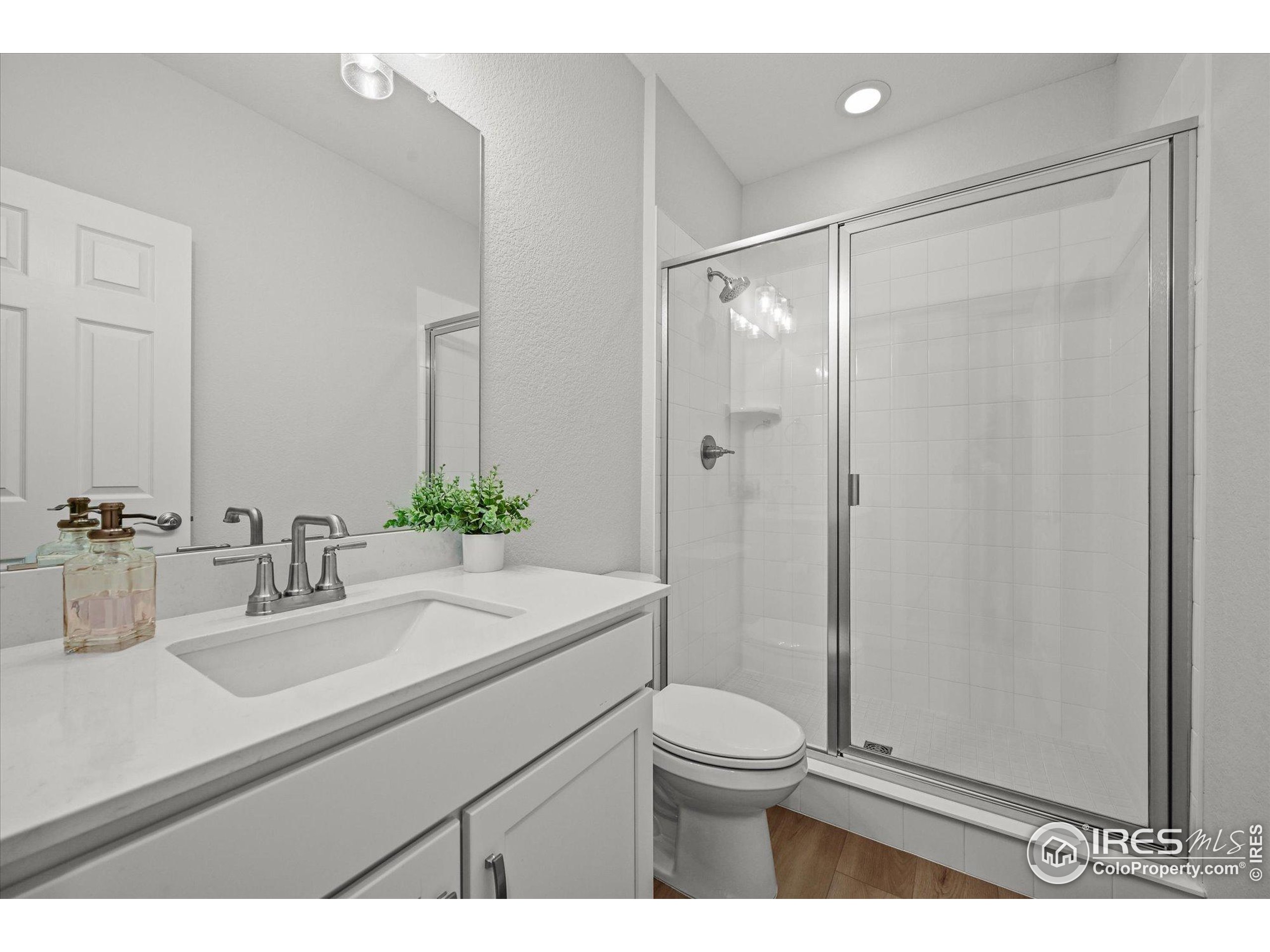 950 Rustling Street Windsor, CO 80550 - Photo 13 of 49 a bathroom with a sink a toilet and shower