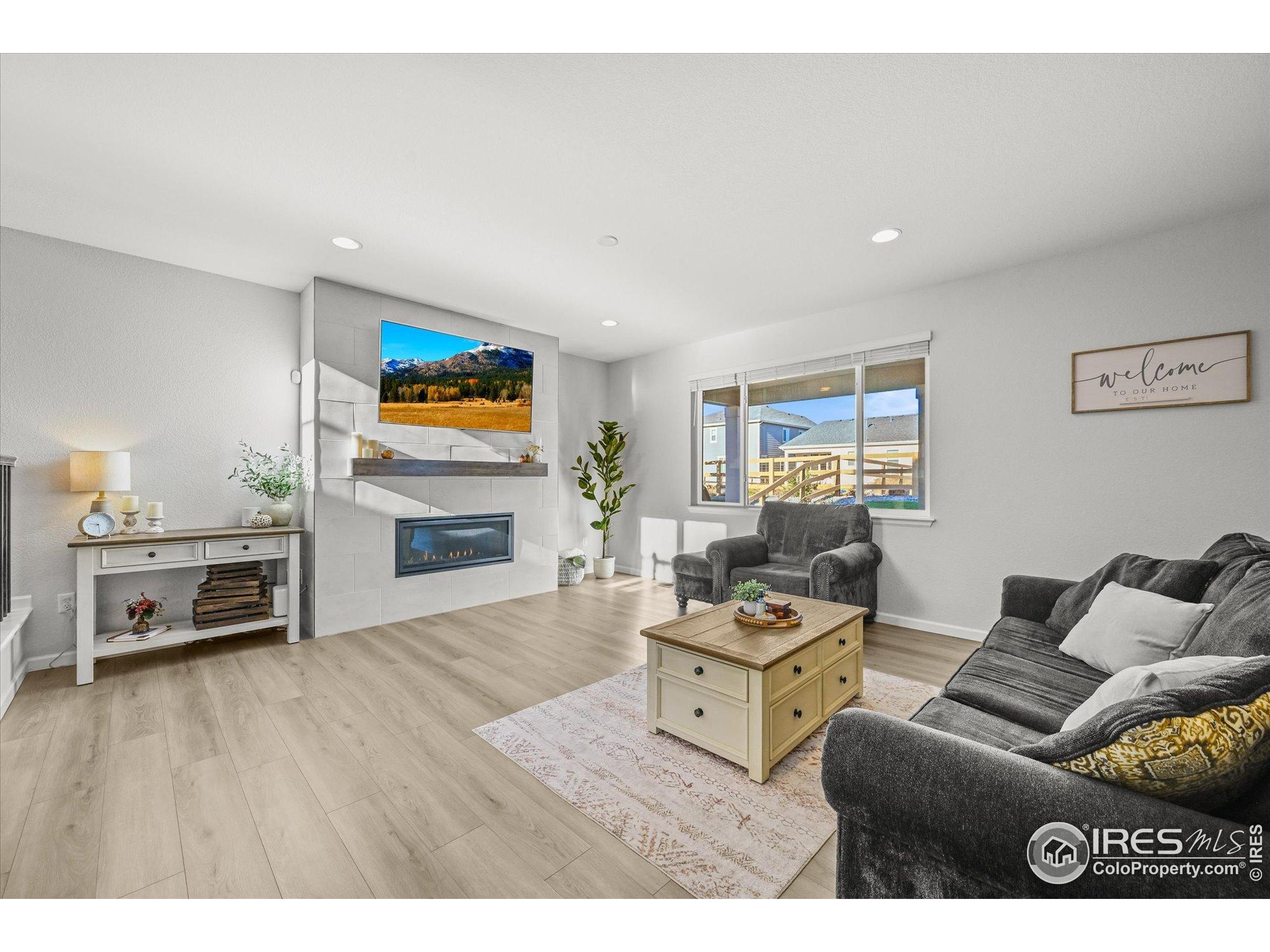 950 Rustling Street Windsor, CO 80550 - Photo 15 of 49 a living room with furniture and a flat screen tv