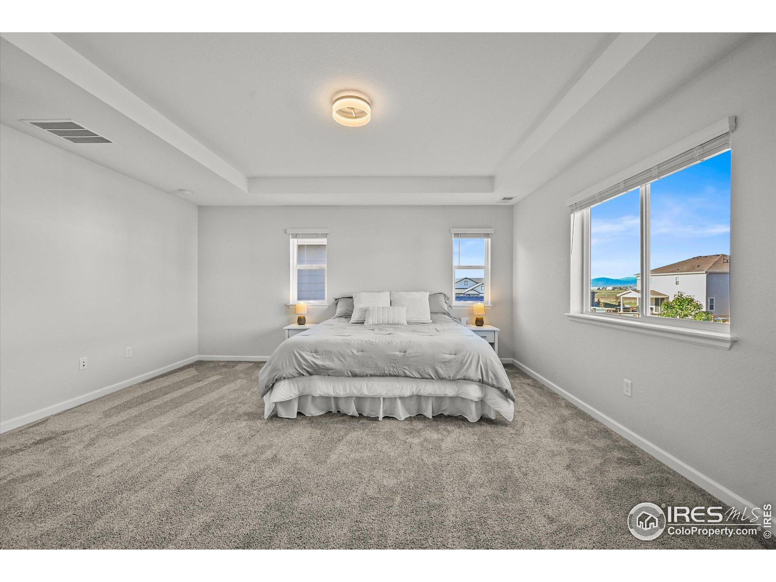 950 Rustling Street Windsor, CO 80550 - Photo 20 of 49 a spacious bedroom with a bed and a window