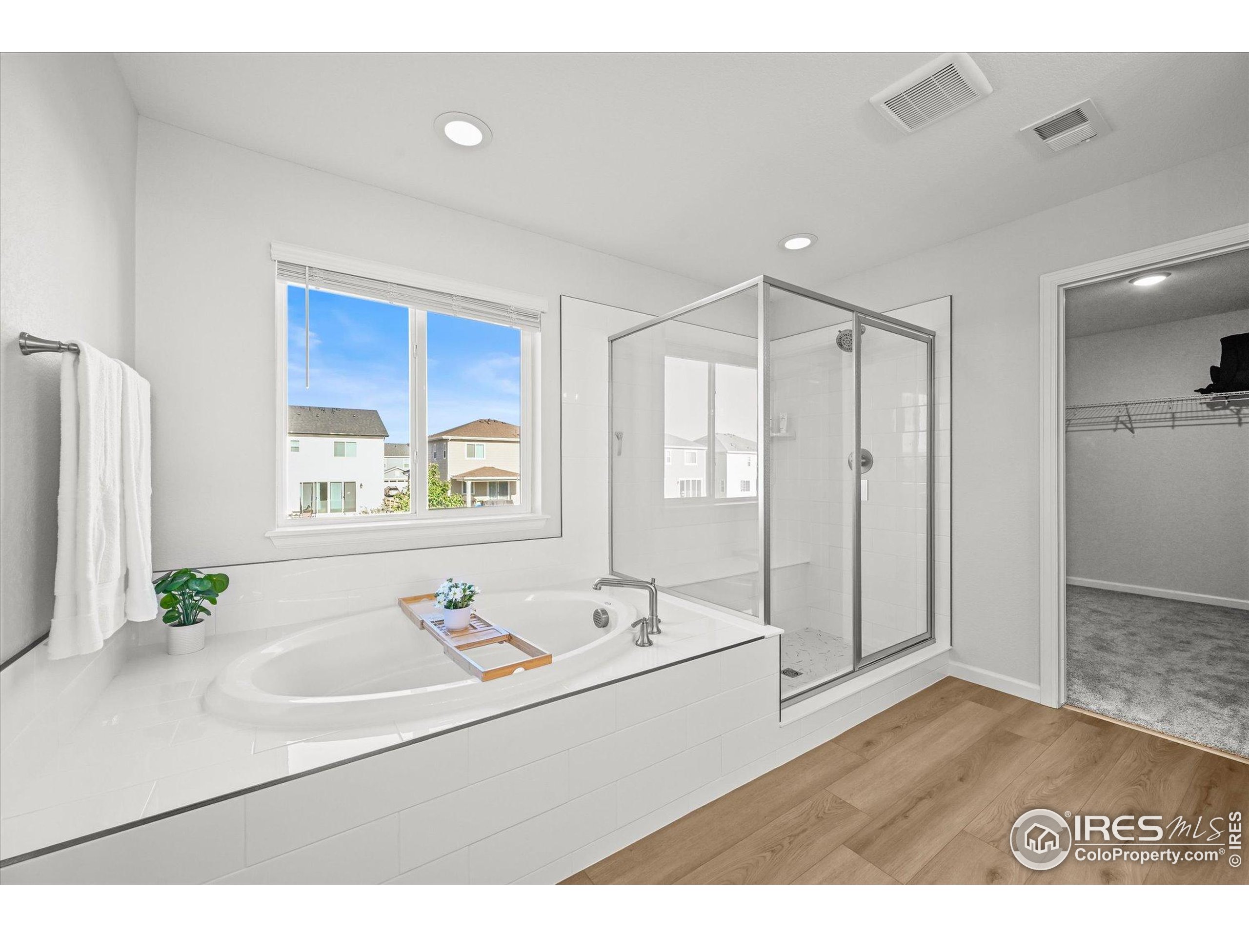 950 Rustling Street Windsor, CO 80550 - Photo 22 of 49 a bathroom with a sink a mirror and a bathtub