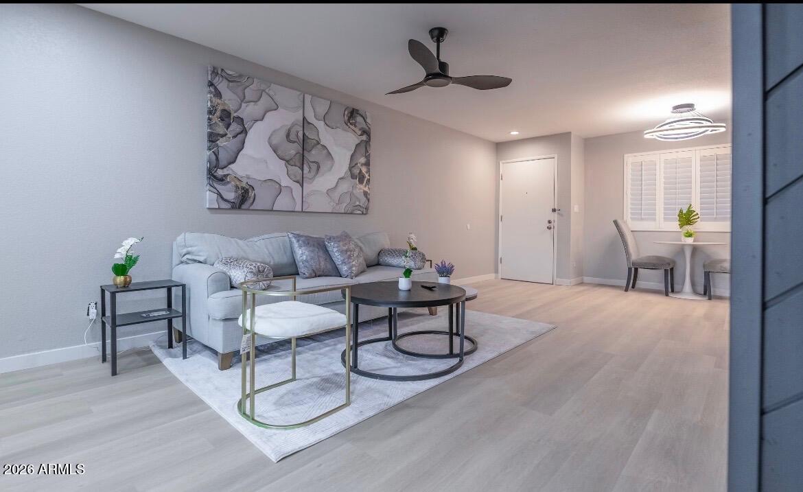 4303 East Cactus Road, Unit 128 Phoenix, AZ 85032 - Photo 18 of 39 a living room with furniture and a wooden floor
