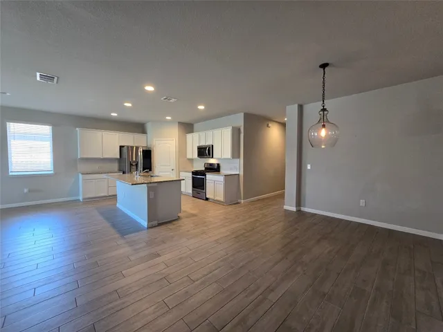 a view of kitchen with cabinets and wooden floor