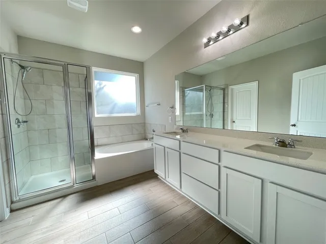 a bathroom with a double vanity sink and a bathtub