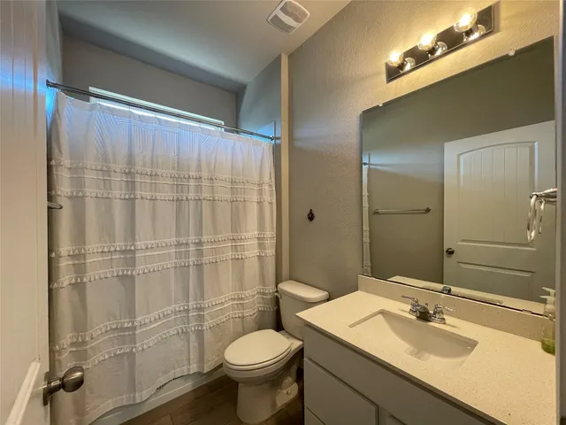 a bathroom with a sink toilet and shower