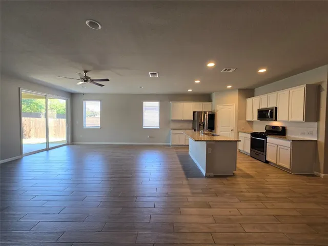 a view of kitchen with wooden floors and windows