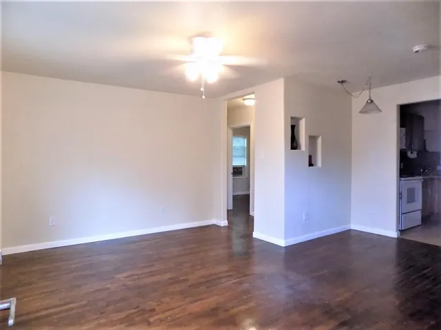 a view of a hallway with wooden floor