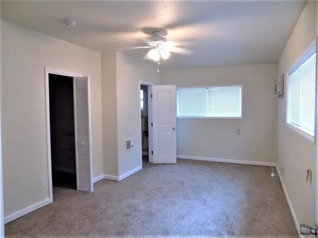 a view of an empty room with a fan