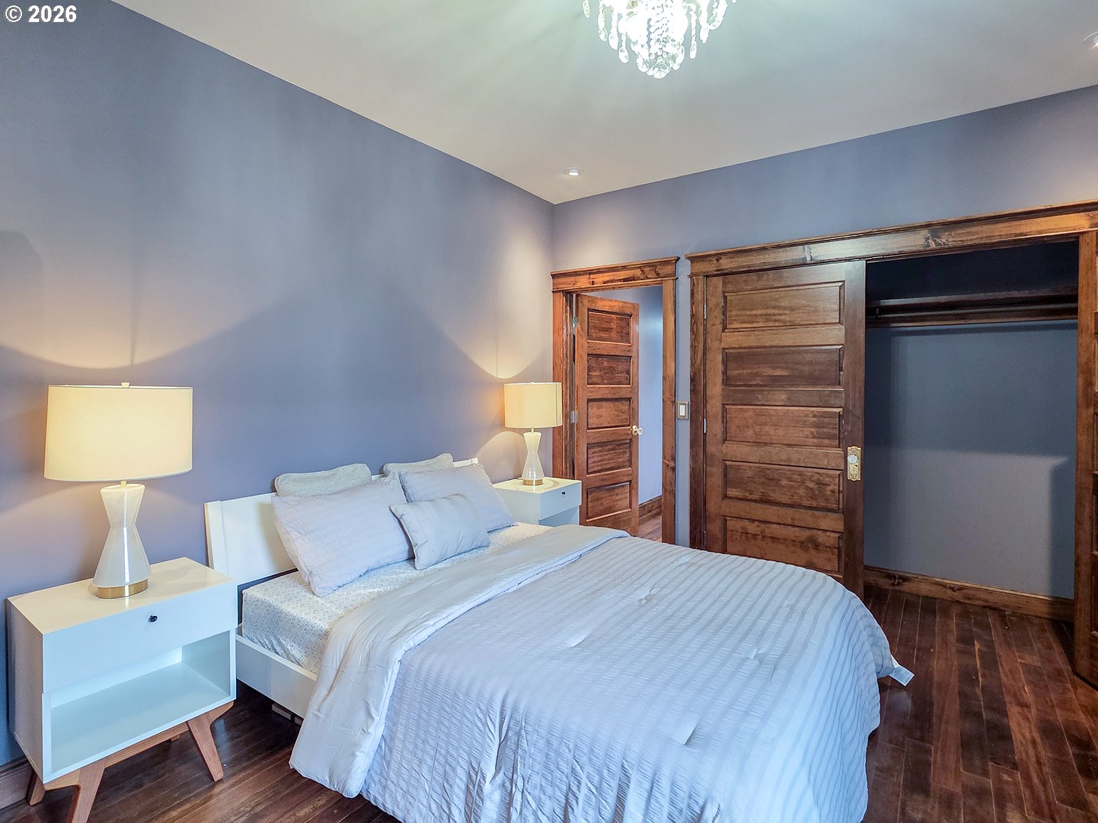 4725 Northeast 22nd Avenue Portland, OR 97211 - Photo 15 of 46 a bedroom with a bed and a lamp
