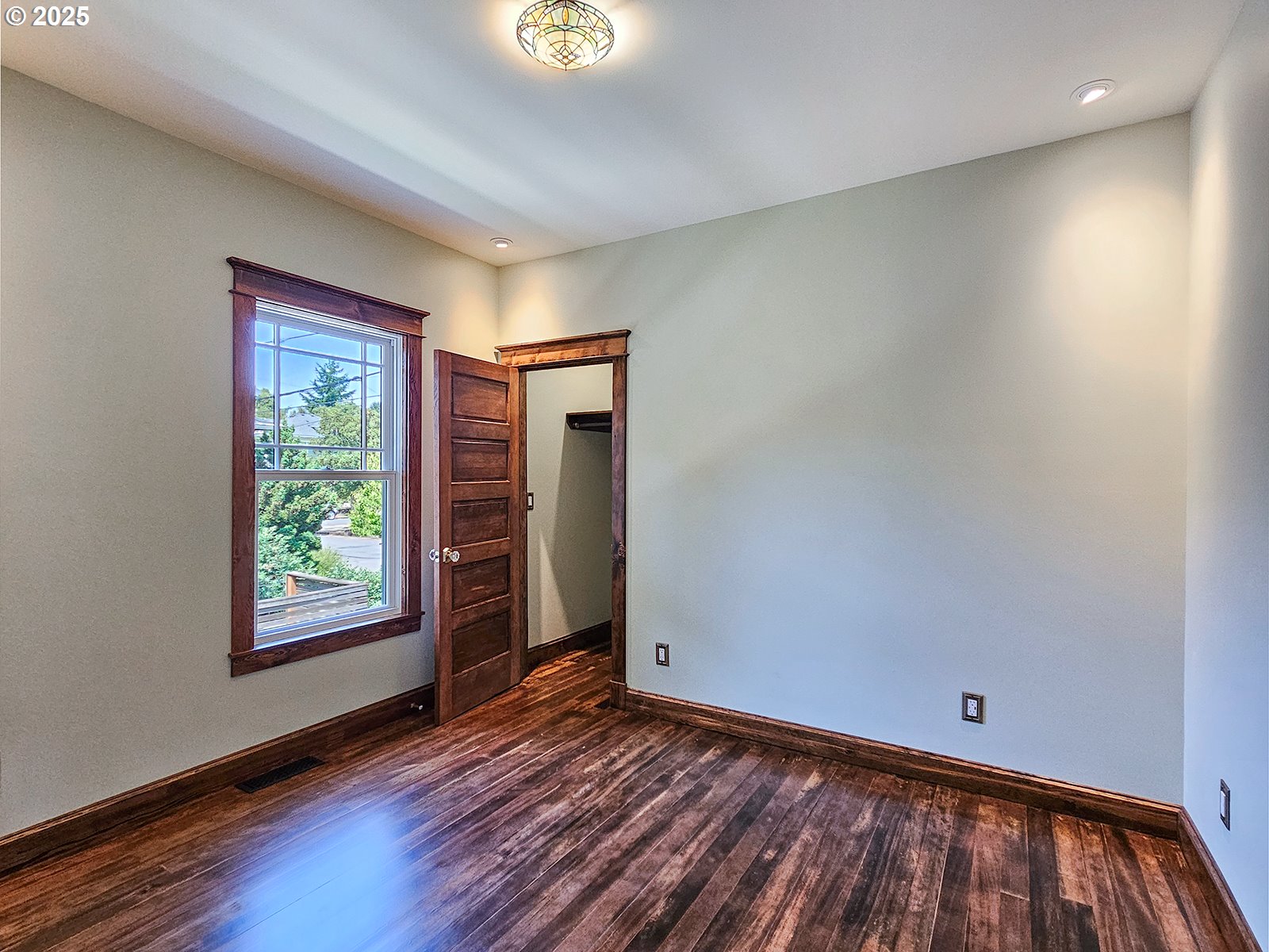 4725 Northeast 22nd Avenue Portland, OR 97211 - Photo 19 of 46 a view of an empty room with wooden floor and a window