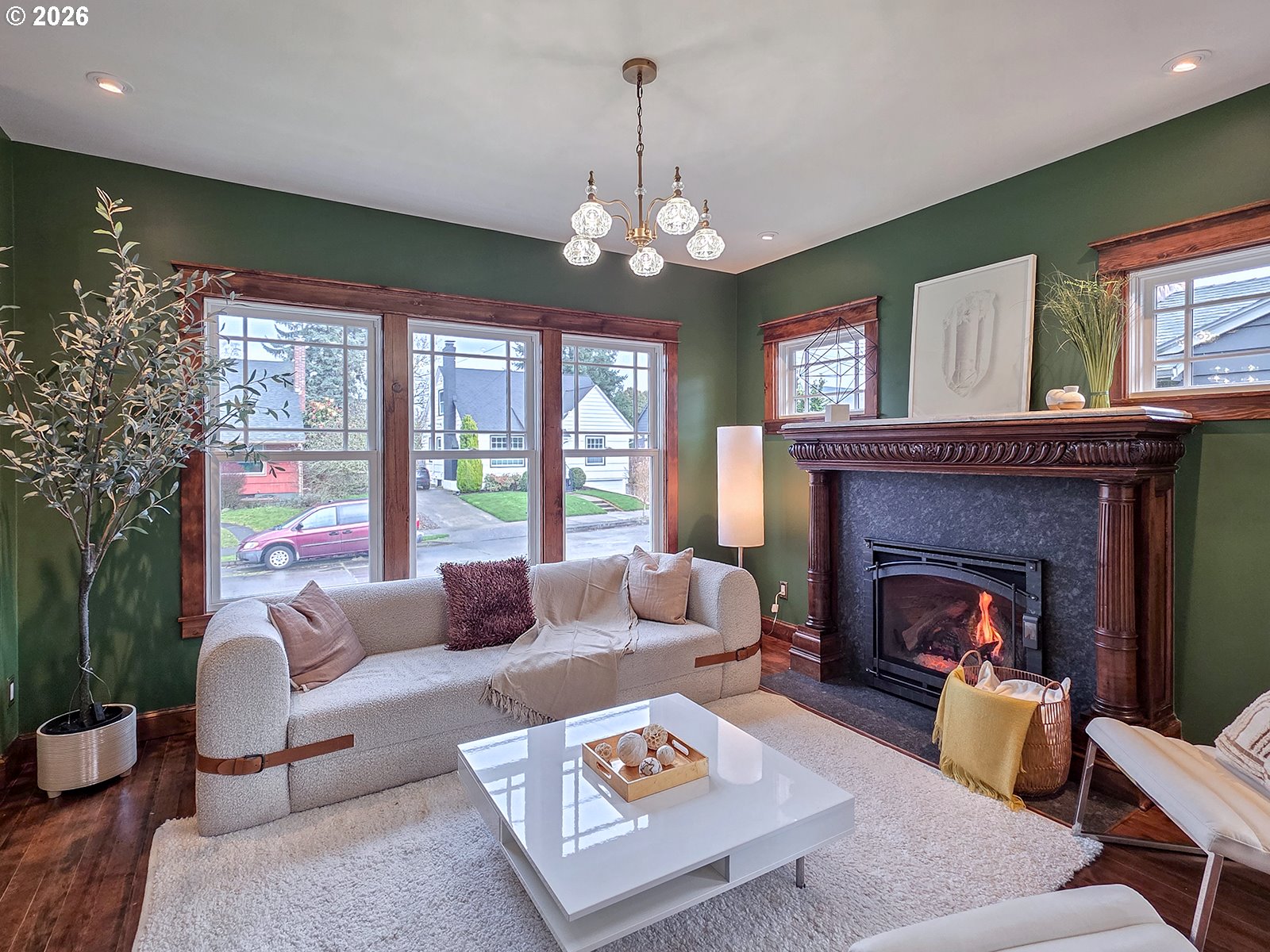4725 Northeast 22nd Avenue Portland, OR 97211 - Photo 5 of 46 a living room with furniture chandelier and a fireplace