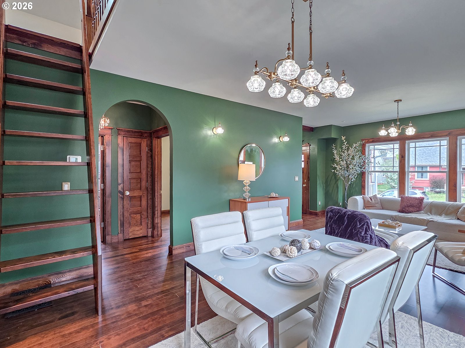 4725 Northeast 22nd Avenue Portland, OR 97211 - Photo 7 of 46 a view of a dining room with furniture a chandelier and wooden floor