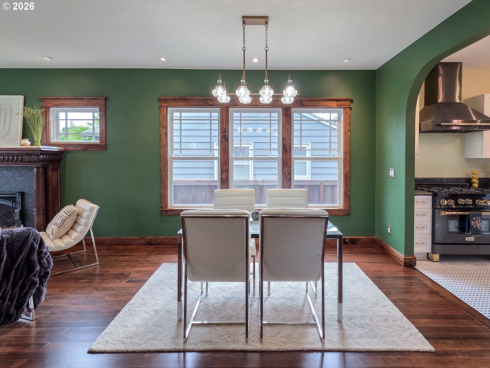 4725 Northeast 22nd Avenue Portland, OR 97211 - Photo 8 of 46 a view of a dining room with furniture a chandelier and wooden floor