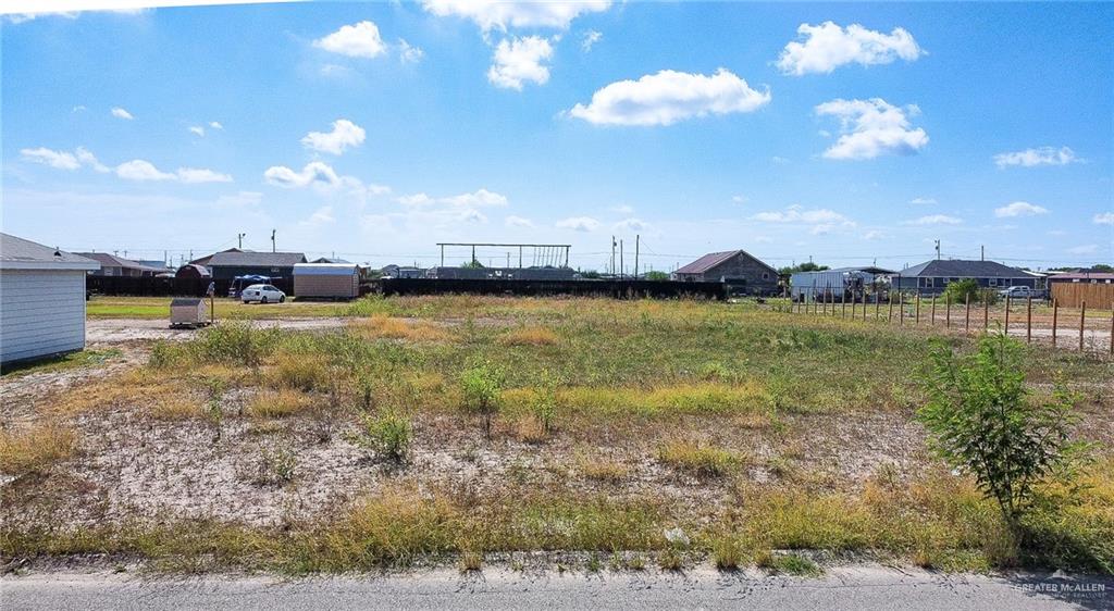 a view of a lake with houses in back